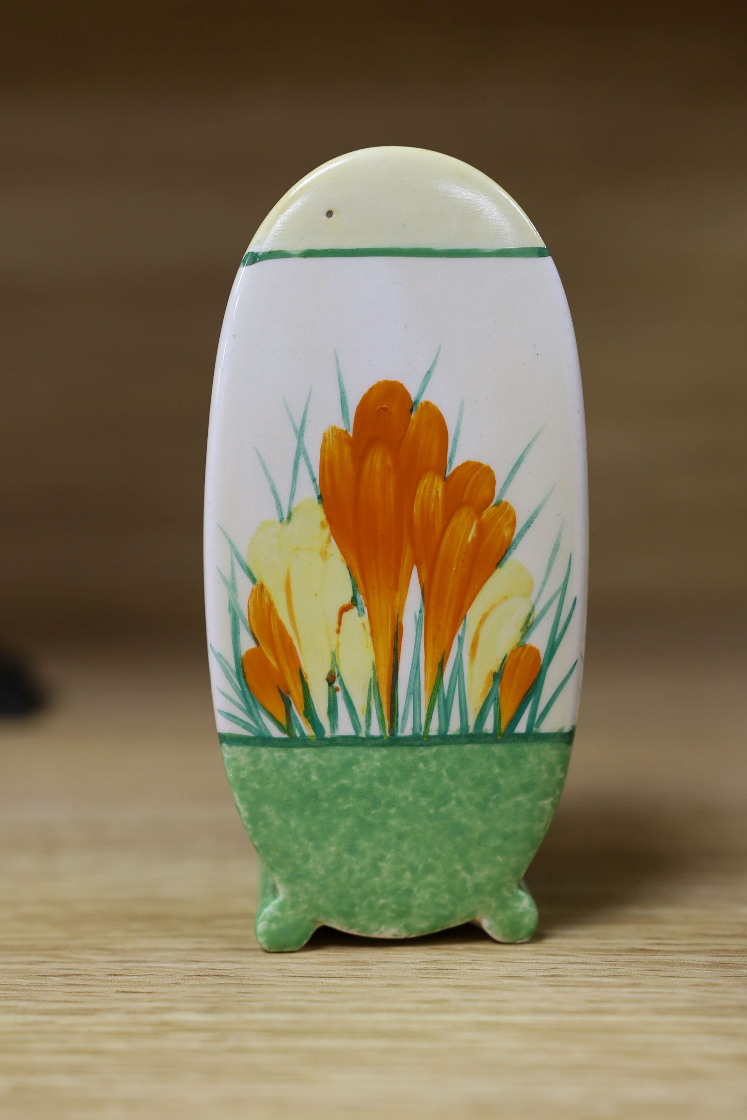 A Clarice Cliff sungleam crocus jam pot and cover, a sugar shaker and a Dutch clog ornament (3), jam pot and cover 10 cms high